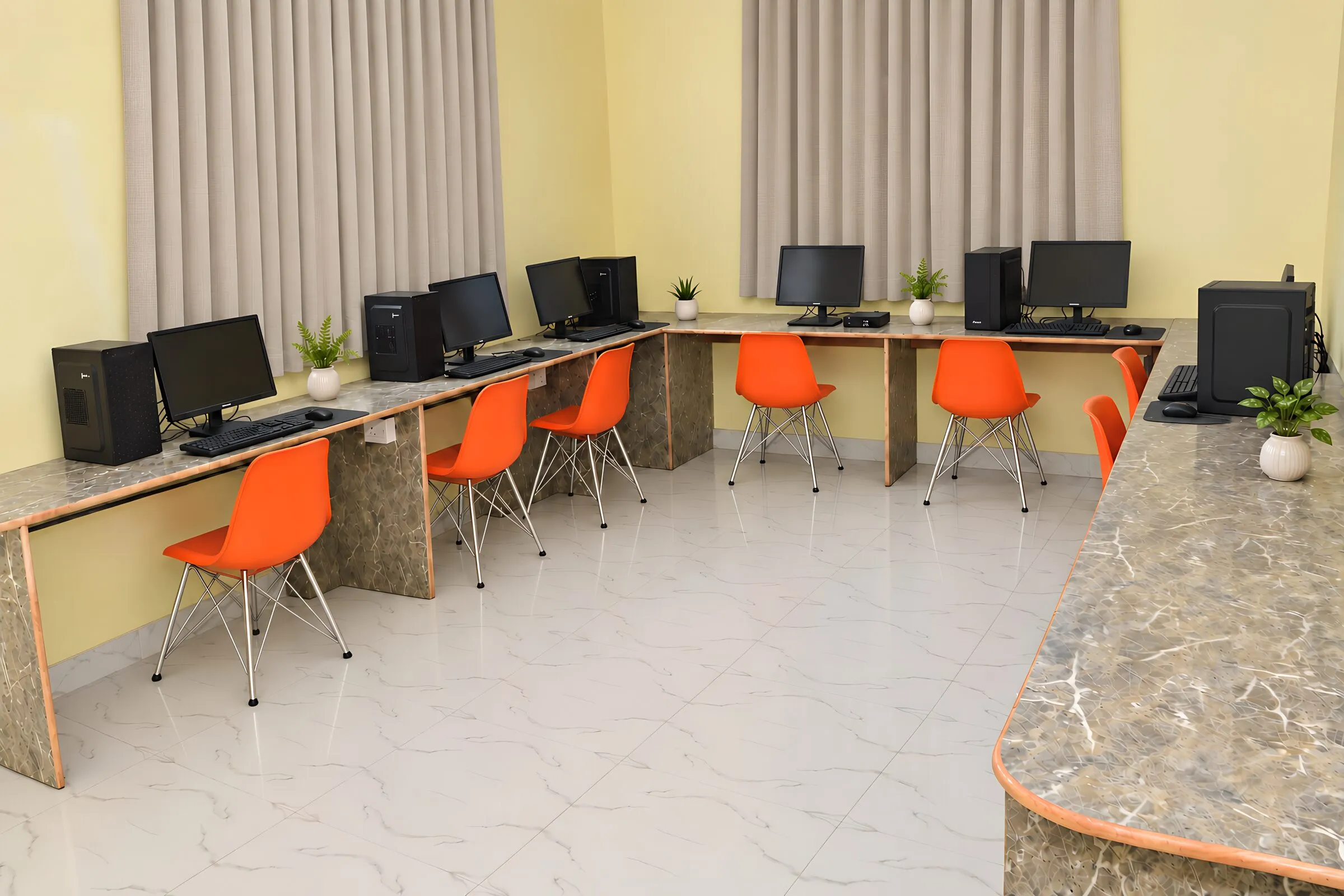 The computer lab: computers along the walls, with orange chairs
