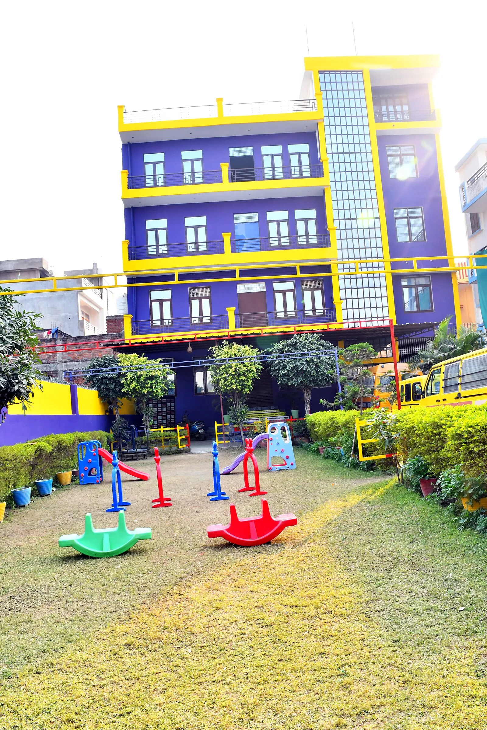The playground lawn and see-saws, with the school building behind