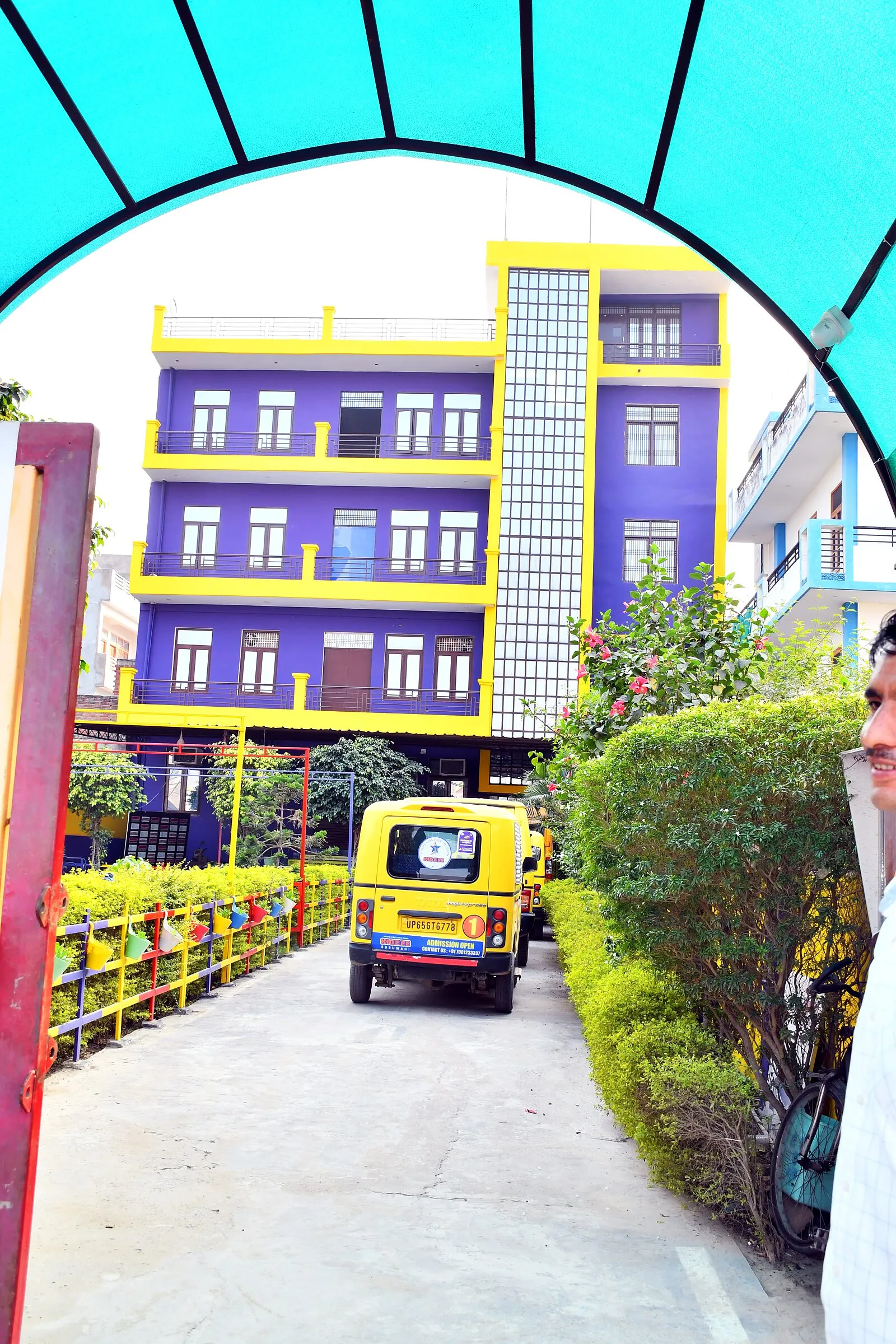 The school building seen through the arch of the gate canopy