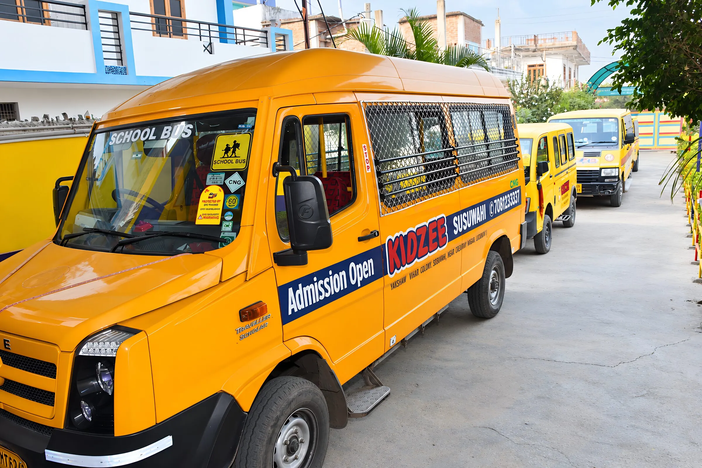 A school van from the front, with more parked in a row behind it